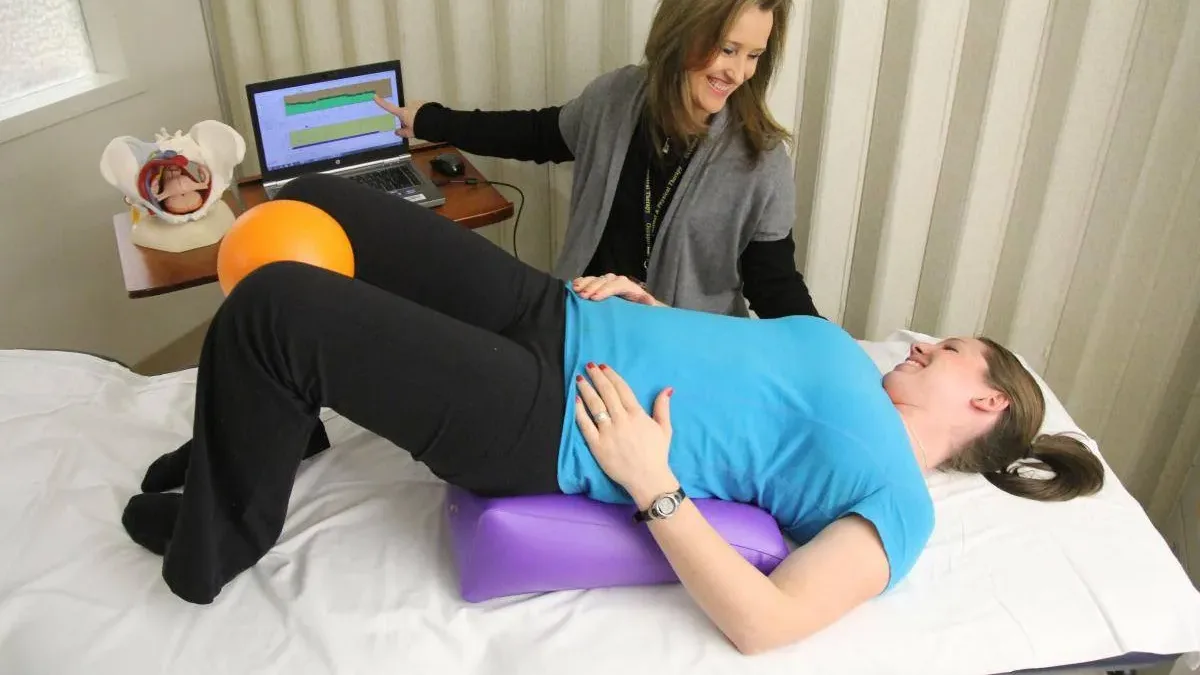 Pelvic floor physical therapy session with biofeedback and positioning support